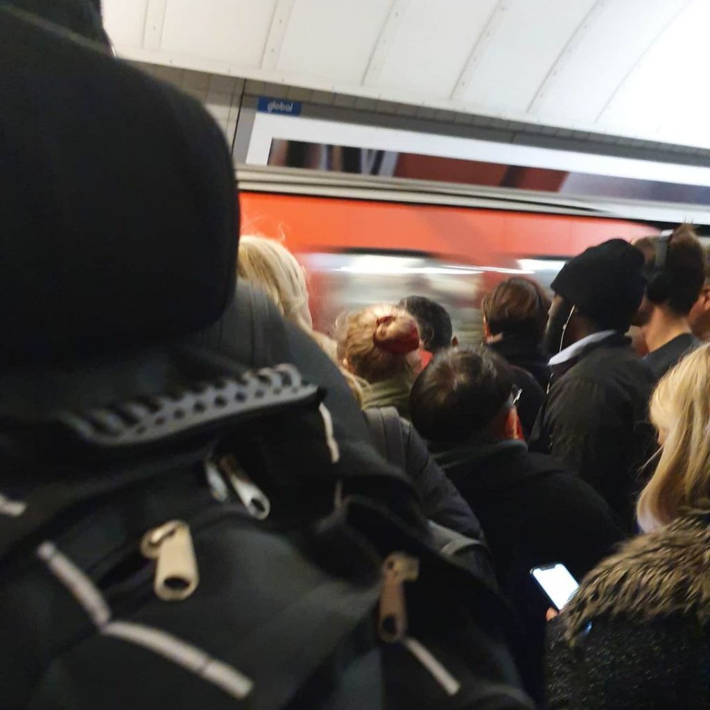 Crowd waiting to get on the tube in London.