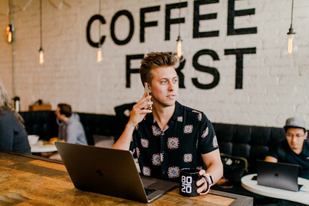 Young men sitting in a coffee shop to work.